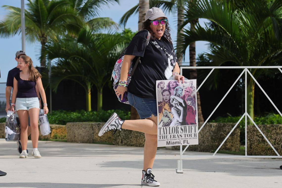 Janier Sideregts, 47, reacts as she leaves with a poster from the Taylor Swift Eras Tour merchandise store at Hard Rock Stadium in Miami Gardens, Florida, Wednesday, October 16, 2024.