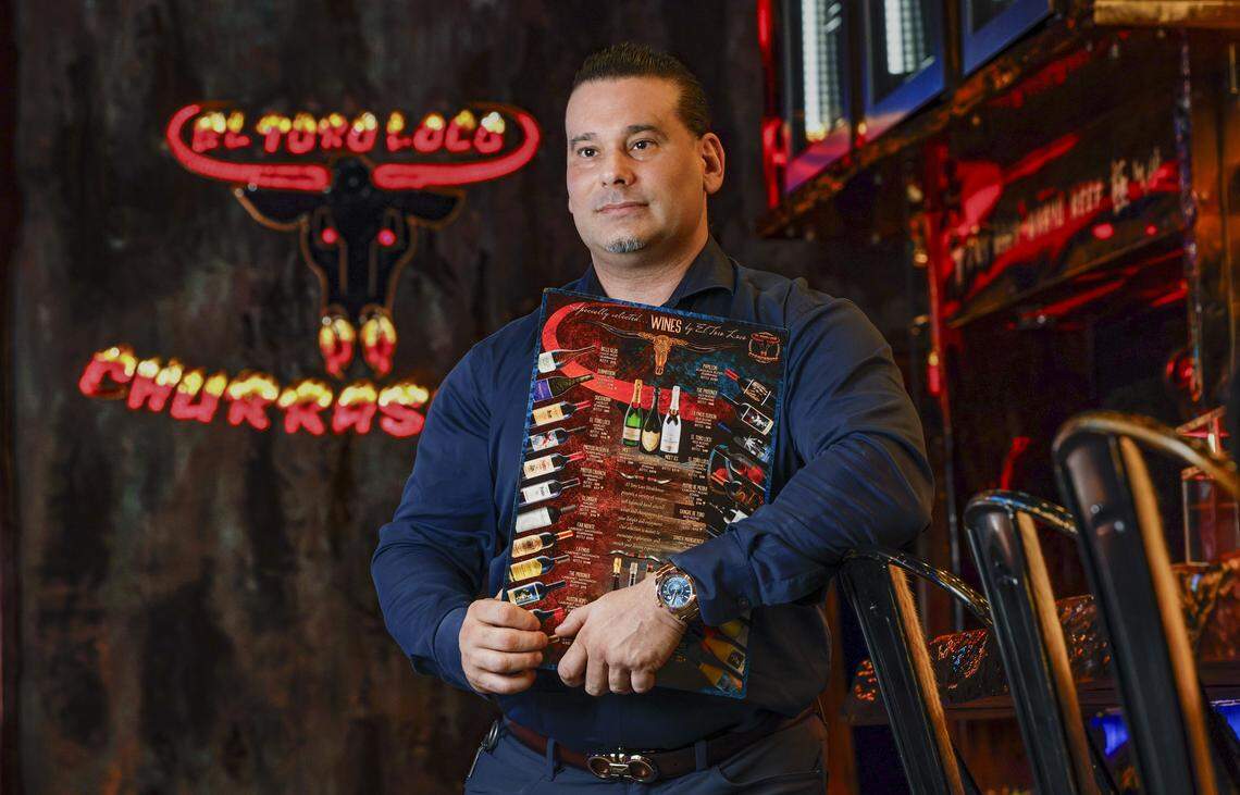 Chef and owner Aldo Espinosa delivers menus at the Little Havana restaurant. The menus come with photos of the food, particularly the platters, so customers have a better idea of what they’re getting.