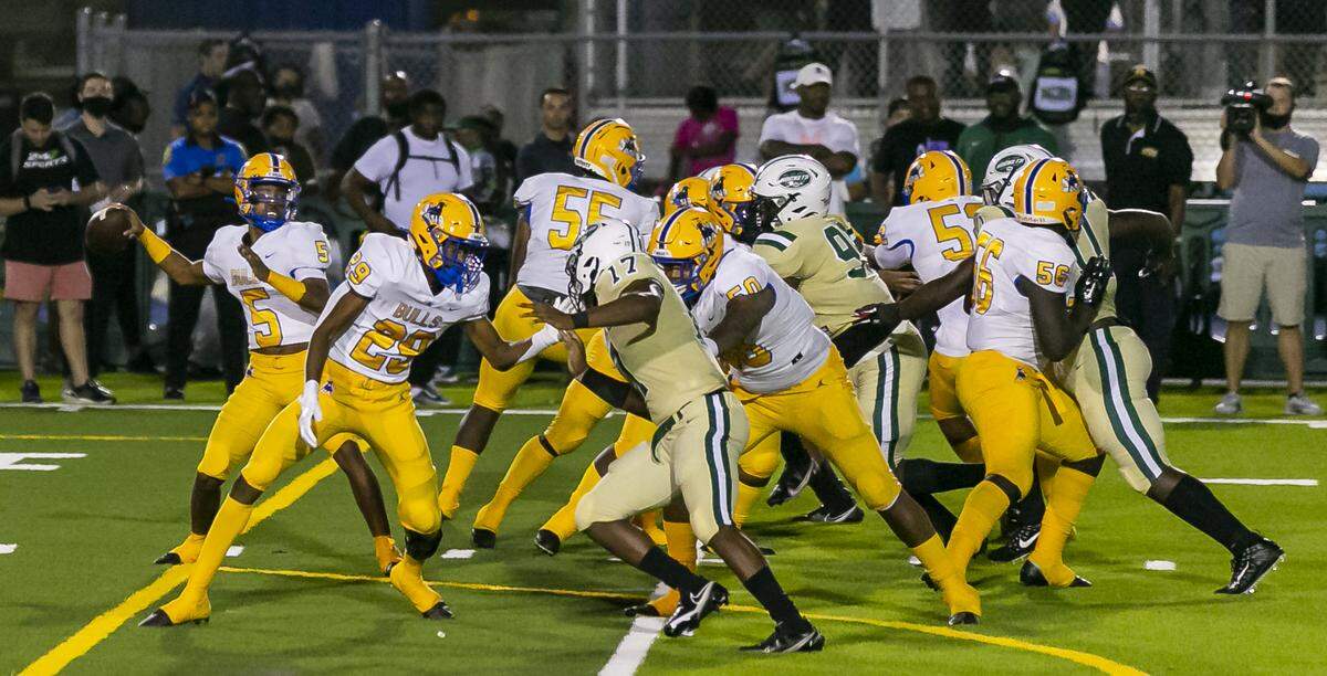 Northwestern Bulls quarterback Taron Dickens (5) looks to pass the ball during a football game against the Miami Central Rockets on Friday, October 1, 2021 at Nathaniel Traz Powell Stadium in Miami, Florida.
