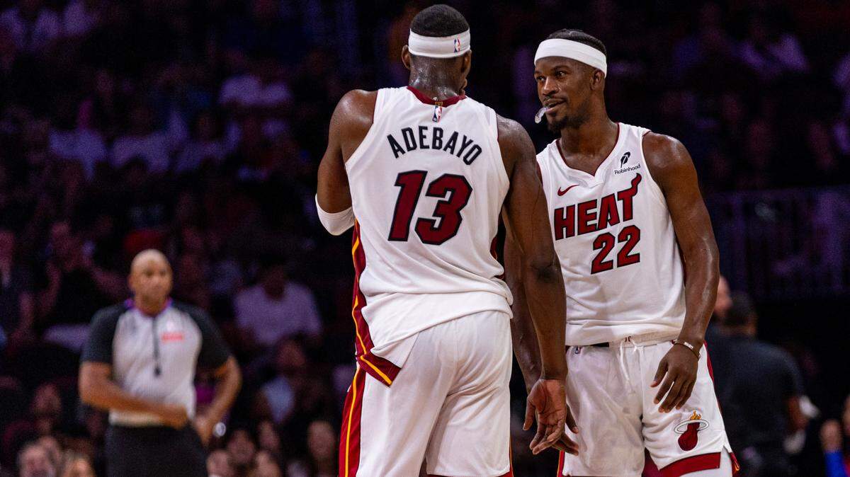 Miami Heat forward Jimmy Butler (22) speaks with teammate Bam Adebayo (13) during an NBA game at Kaseya Center on October 28, 2024, in Miami.
