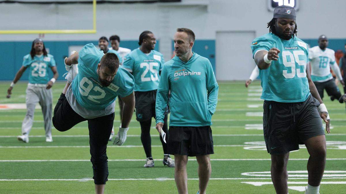 Head Coach Jeff Hafley talks to defensive lineman Zach Sieler (92) during warmups at Miami Dolphins organized training activities on Tuesday, May 19, 2026, at Baptist Health Training Complex in Miami Gardens, Fla.