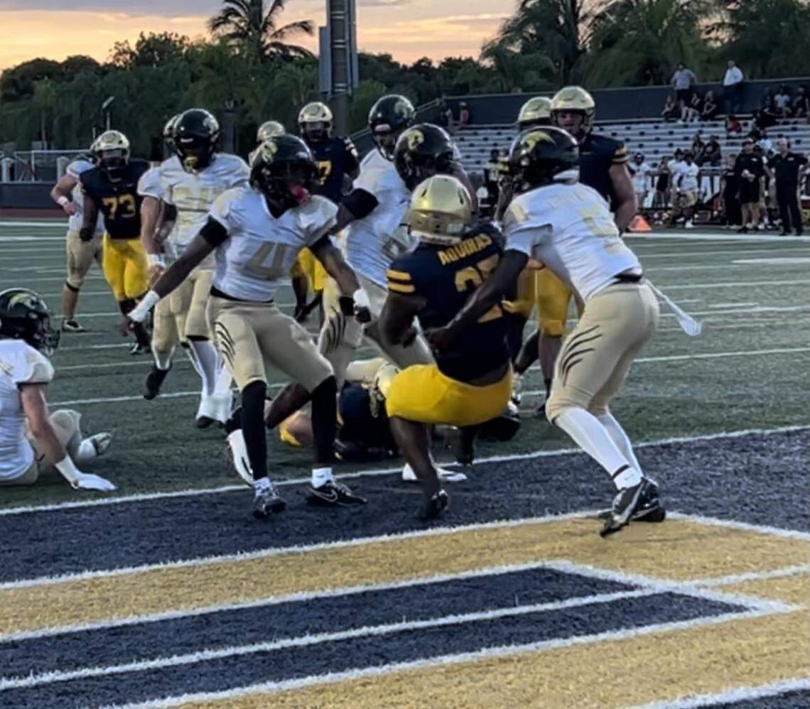 St. Thomas Aquinas running back Jordan Montgomery backs his way into the end zone for one of his two touchdowns during a 48-22 Raiders’ victory over Davie Western on Thursday night at St. Thomas.