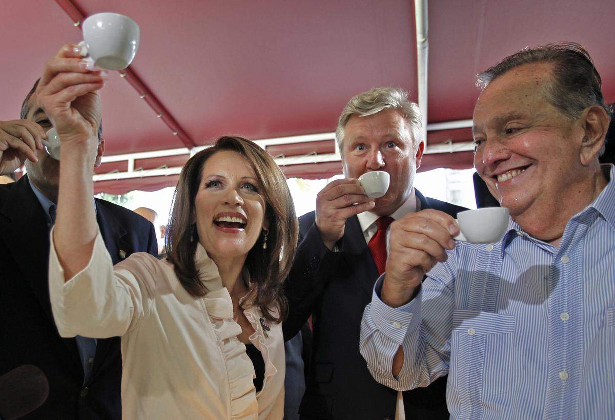 Michele Bachmann, center, raises her cup as she samples Cuban coffee alongside Felipe A. Valls, owner of Versailles, right, her husband, Marcus, and Congressman David Rivera, left, at the counter of Versailles. Presidential candidate Michele Bachmann visited the Bay of Pigs Museum in Little Havana and made a stop by the famous Cuban eatery Versailles during a stop in Florida on the campaign trail in 2011 in Miami, Florida.