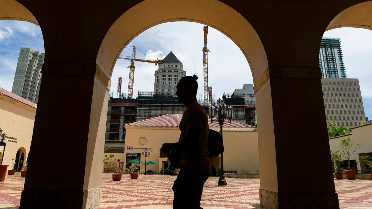 A view of the HistoryMiami museum’s buildings on the Miami-Dade County Cultural Center plaza downtown looking through the arches at the Main Library building. In the background, the new county civil courthouse is under construction.