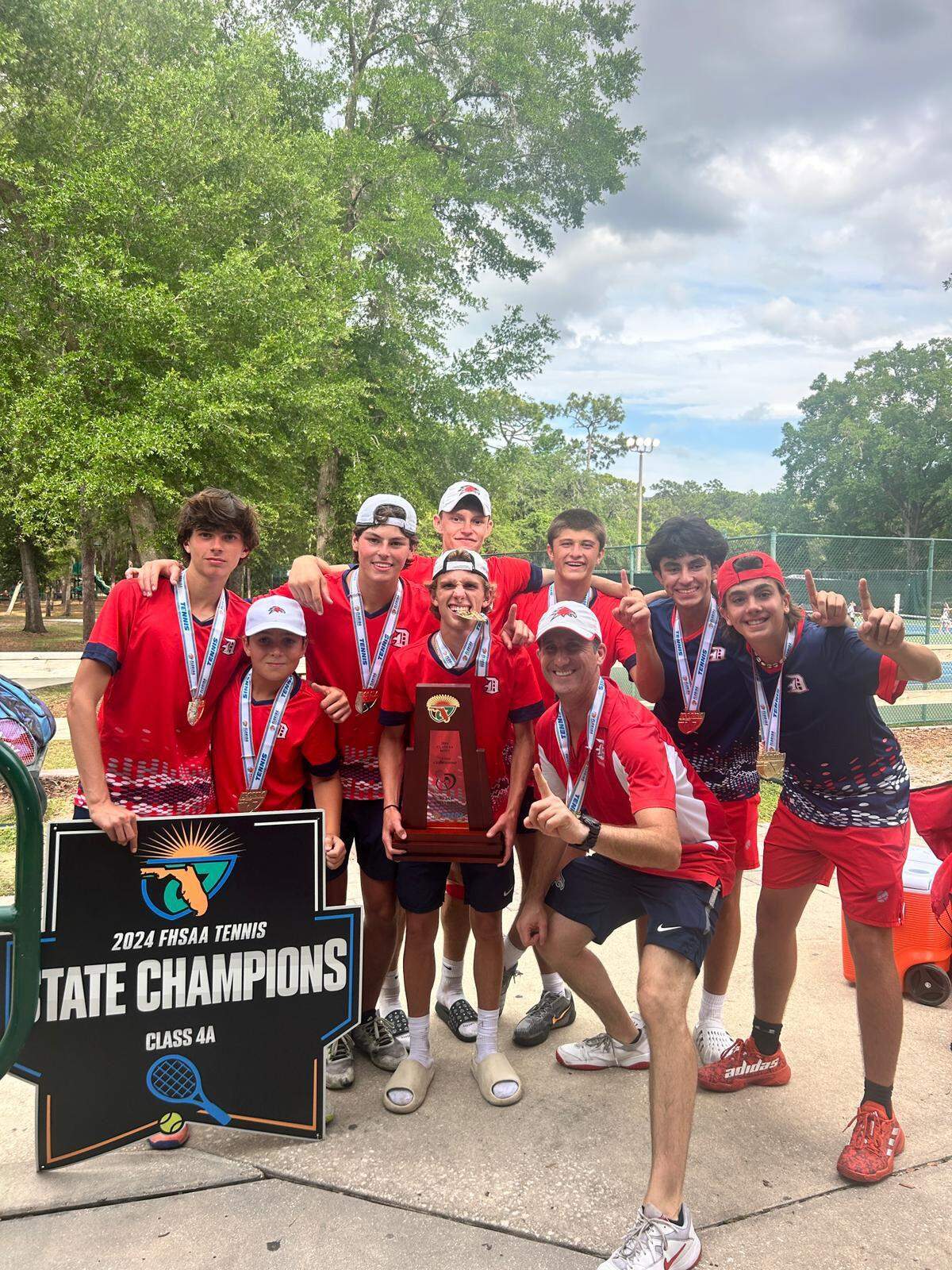 Doral Academy’s boys’ tennis team celebrates after winning the Class 4A boys championship on Tuesday in Altamonte Springs, Fla.