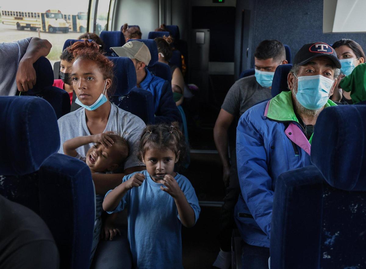 On Sunday September 18, 2022 as a bus full of people from Venezuela, Nicaragua and Cuba await to be shuttled away Eagle Pass, TX by a group of volunteers from the League of United Latin American Citizens, as more asylum seekers were wading through the mostly-shallow waters of the Rio Grande from Piedras Negras, Mexico across the US Southern border.