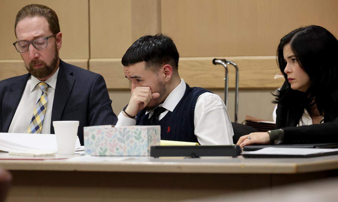 Jason Banegas, along with his attorneys Michael Orlando and Lien Lafargue, watches his police interrogation video after the shooting of Hollywood Police Officer Yandy Chirino is played in court during his sentencing trial before Judge Ernest Kollra on Tuesday, Dec. 2, 2025. Banegas pleaded guilty in October to the 2021 shooting death of Hollywood Police Officer Yandy Chirino. (Mike Stocker/South Florida Sun Sentinel)