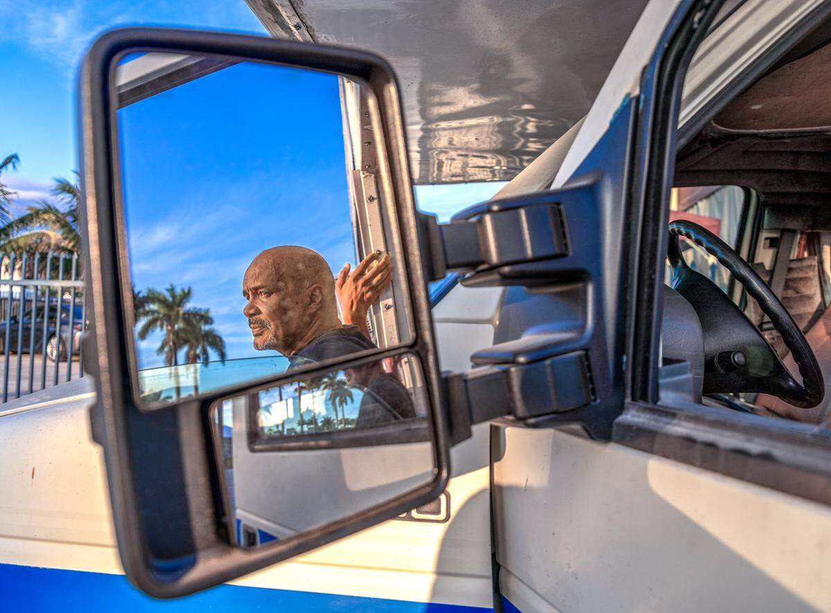 Angel Rogelio Diaz Franco, who was evicted from his home of 19 years in October, has ALS and is unable to work. With no money to find a new home, he stands outside the camper van in which he now lives on Sunday, Dec. 21, 2025, in Miami.
