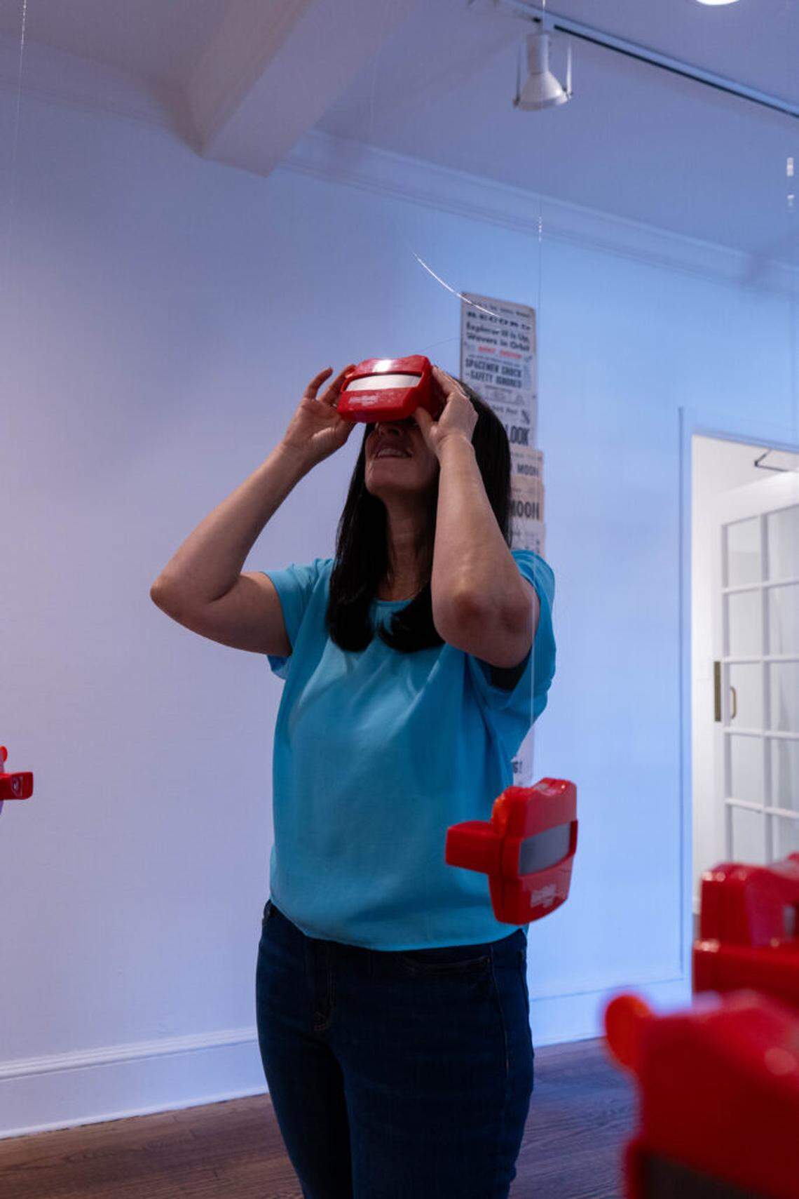 Hanging View-Masters, cultural relics, invite viewers to peer into miniature images of the universe.