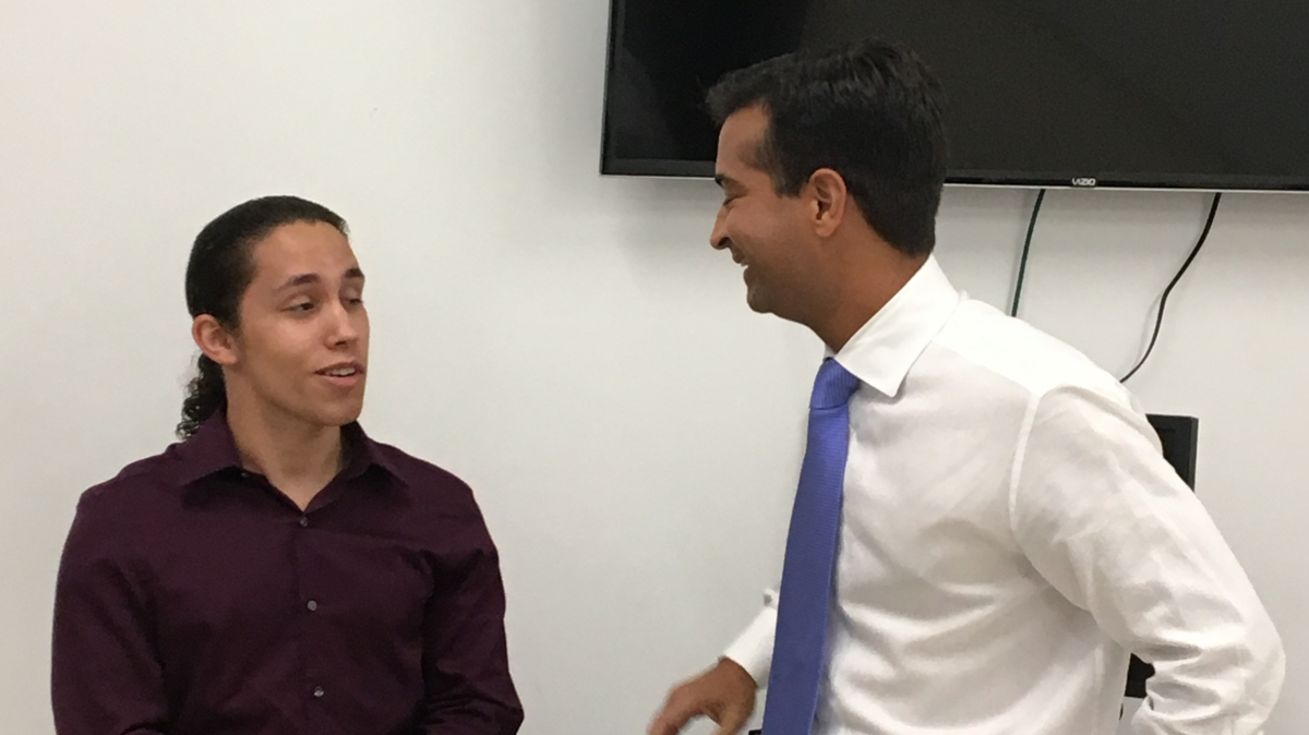 Rep. Carlos Curbelo, right, speaks with 19-year-old Pierre Alejandro Verges-Castro, a constituent who threatened to kill Curbelo in a social media posting last week.