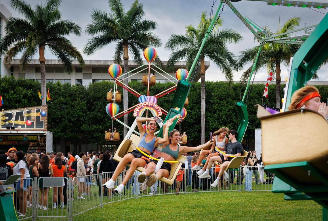 Amelia Fontana, left, and Maria Islam smile on a ride in the middle of campus during the University of Miami Centennial celebration on Tuesday, April 8, 2025, on Foote University Green at the University of Miami’s Coral Gables campus.
