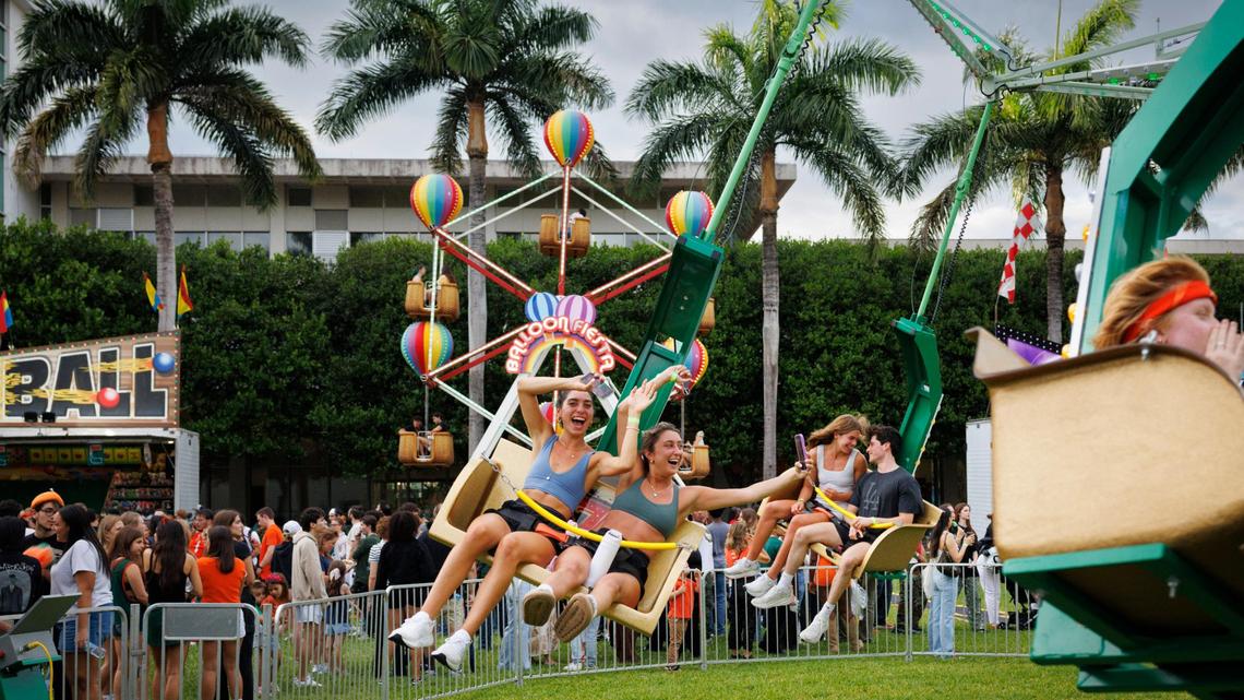 Amelia Fontana, left, and Maria Islam smile on a ride in the middle of campus during the University of Miami Centennial celebration on Tuesday, April 8, 2025, on Foote University Green at the University of Miami’s Coral Gables campus.