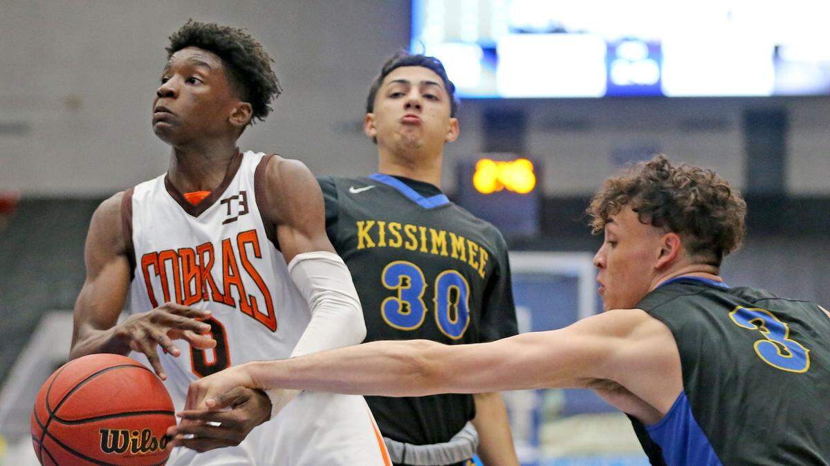South Miami HS Arturo Dean (0) gets the ball knocked from his hands by Osceola HS Jeremiah Palermo (3) in the 9A Boy’s Semi-Finals State Basketball Championships at the RP Funding Center in Lakeland, Florida, Friday, March, 8, 2019.