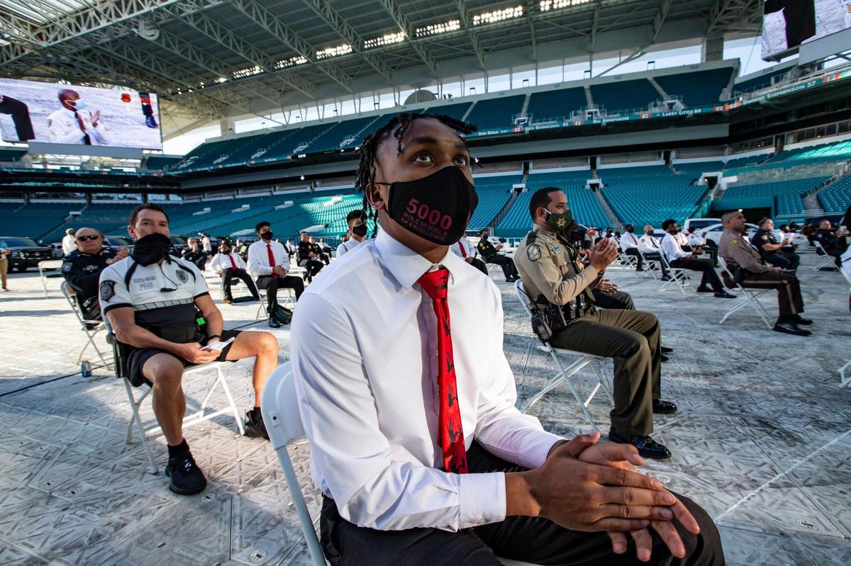 Darius Curry, 18, of Miami Norland Senior High, listens to speakers during the 5000 Role Models of Excellence Project 27th Annual Police & Youth Conference at Hard Rock Stadium on Thursday, June 11, 2020. The director of the Miami-Dade Police Department announced there that the department would ban police chokeholds, effective immediately.