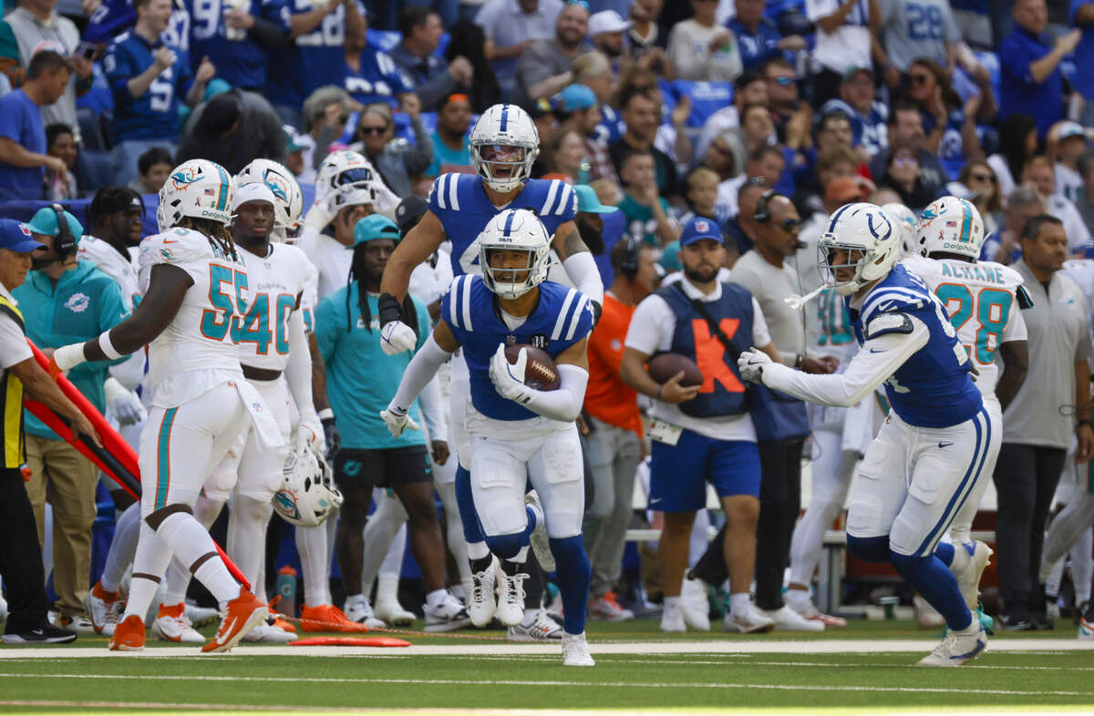 Indianapolis Colts safety Cam Bynum (0) returns an interception against Miami Dolphins quarterback Tua Tagovailoa (1) during the first half of an NFL game at Lucas Oil Stadium on Sunday, September 7, 2025, iIndianapolis, Indiana.
