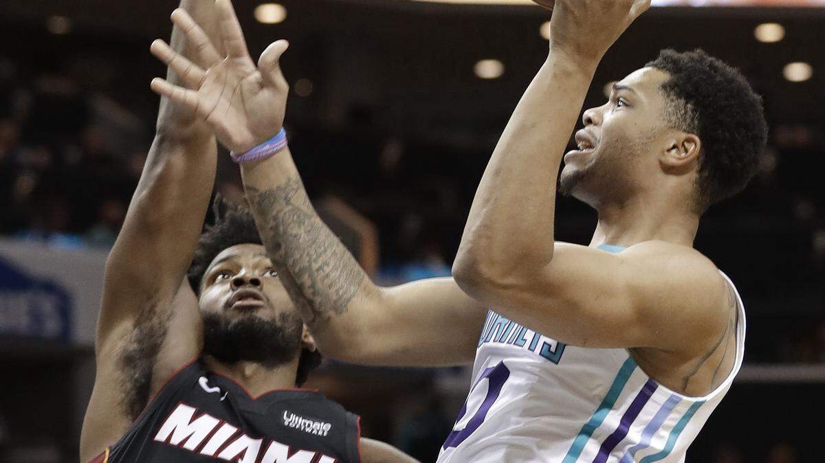 Charlotte Hornets’ Miles Bridges (0) shoots over Miami Heat’s Justise Winslow (20) in the first half of an NBA basketball game in Charlotte, N.C., Tuesday, Oct. 30, 2018.