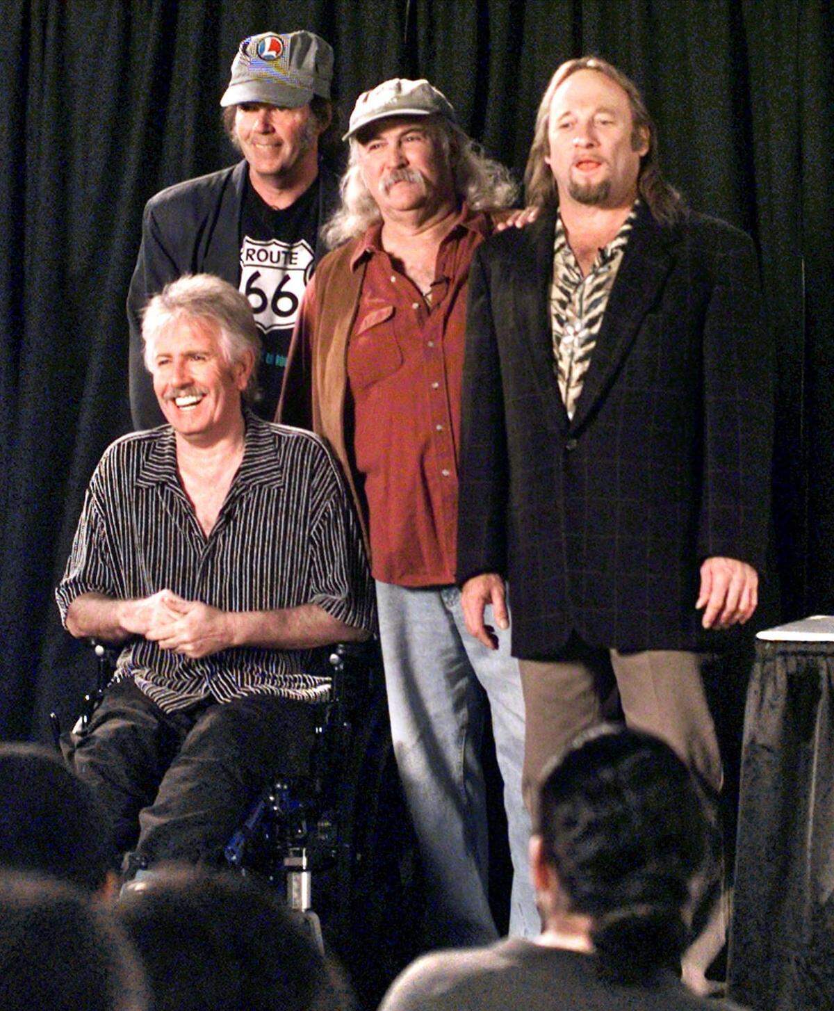 Members of Crosby, Stills, Nash and Young, from left, Graham Nash, seated, Neil Young, David Crosby and Stephen Stills, appear at their “CSNY2K” tour press conference in New York, Oct., 12, 1999. The group, which had last toured together in 1974, released the album, “Looking Forward,” that year ahead of the 34-city U.S. tour that brought them to South Florida.
