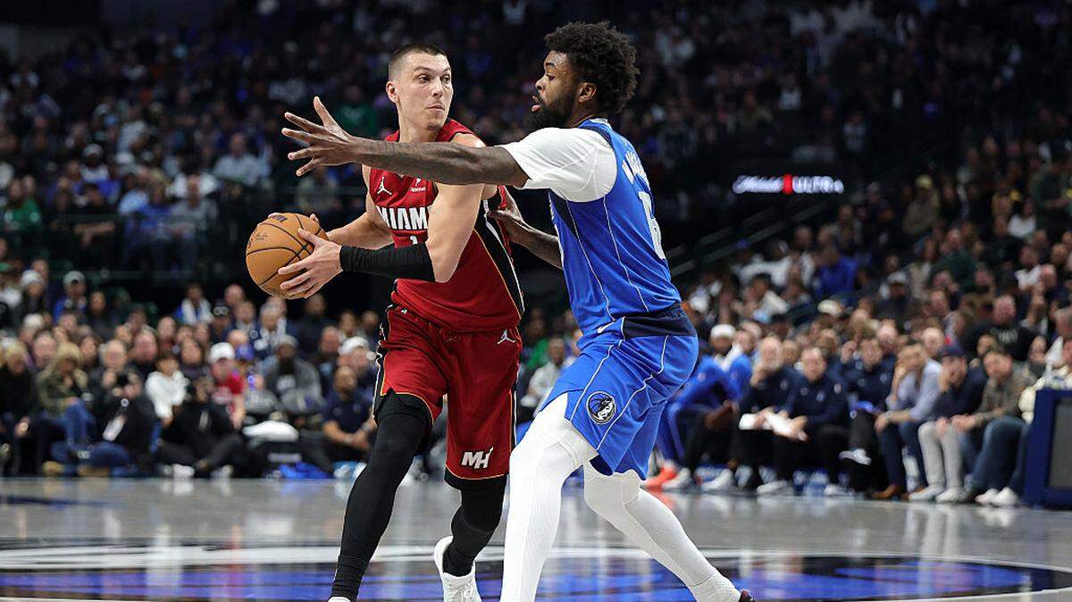 Tyler Herro #14 of the Miami Heat is defended by Naji Marshall #13 of the Dallas Mavericks during the second half at American Airlines Center on December 03, 2025 in Dallas.