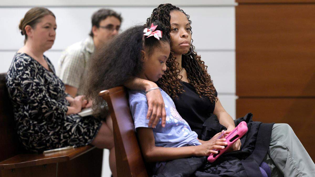 Philana Holmes and her daughter Olivia Caraballo, 7 listen to the final witness in their case at the Broward County Courthouse in Fort Lauderdale on Wednesday May 10, 2023. Holmes and Olivia’s father, Humberto Caraballo Estevez, are suing McDonald’s after their daughter got second-degree burns from a scalding hot chicken nugget. Mike Stocker South Florida Sun Sentinel