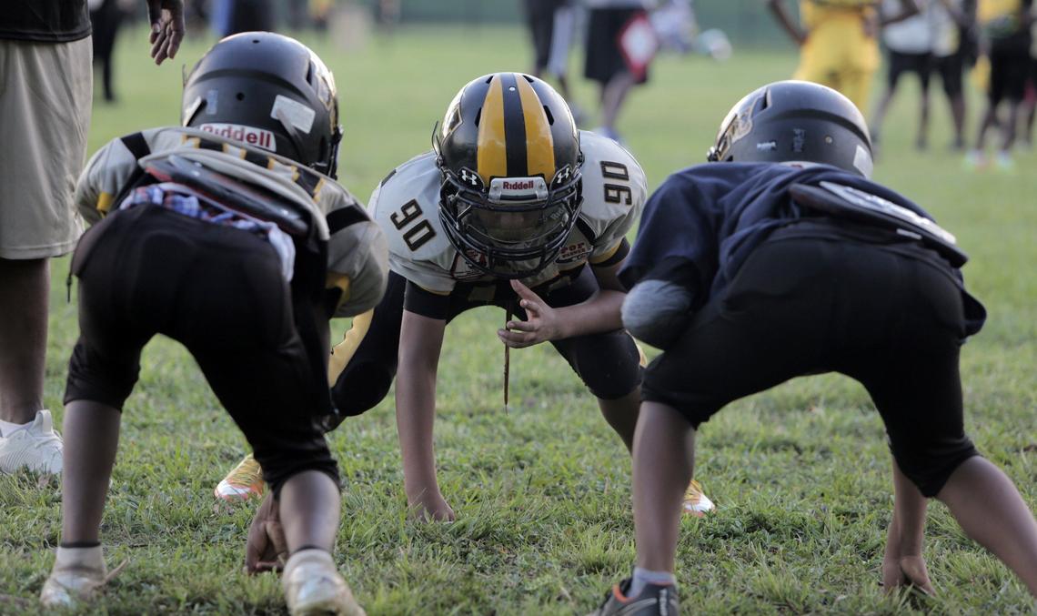 Members of the Liberty City Warriors 100-pound squad go through drills during practice at Charles Hadley Park in Liberty City.