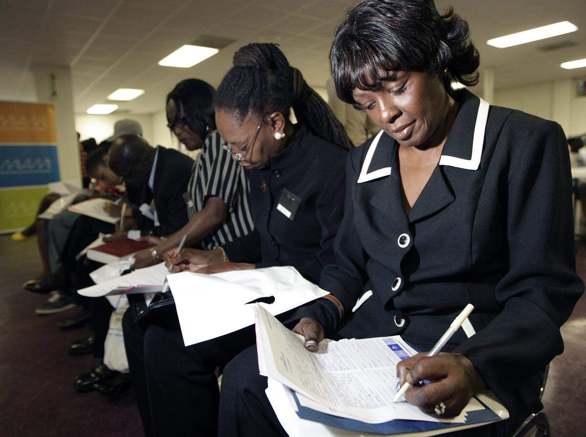 In a Miami Herald file photo from Thursday, Nov. 29, 2007, jobseekers fill out applications for Miami-area hotels at a job fair at the Greater Bethel AME Church in Miami’s Overtown neighborhood.