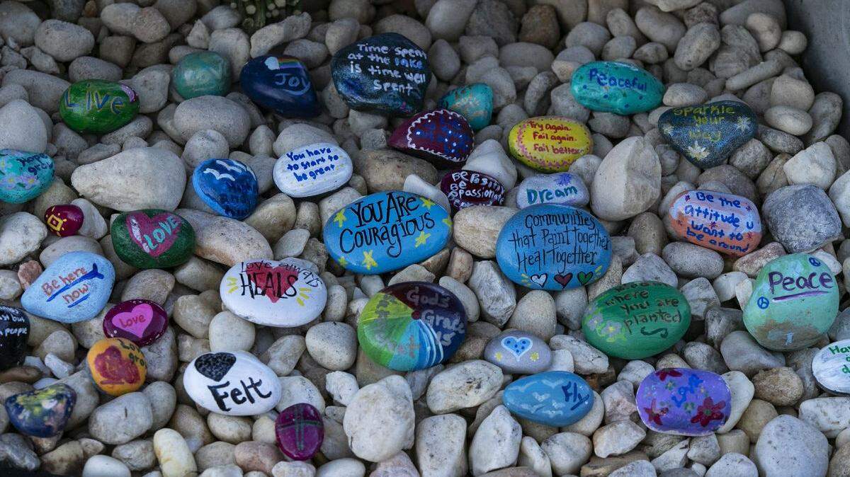 Painted stones adorned a memorial outside Marjory Stoneman Douglas High School during the one-year anniversary of the school shooting in 2019.