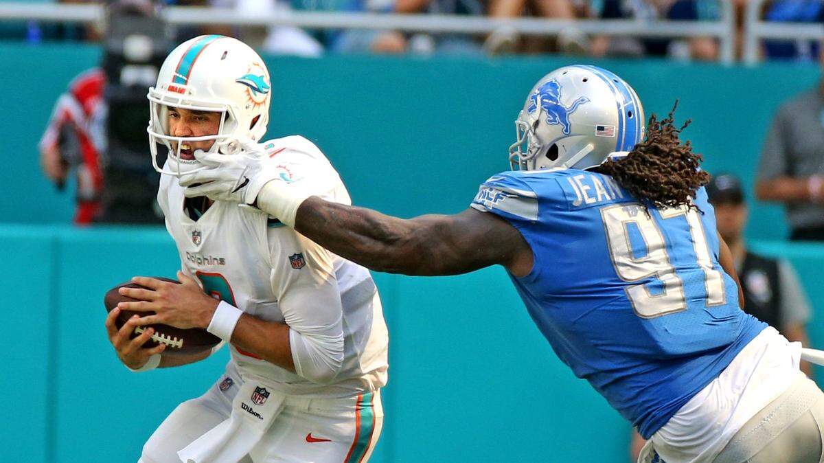 Miami Dolphins quarterback Brock Osweiler gets sacked by Detroit Lions Ricky Jean-Francois in the third quarter at Hard Rock Stadium in  Miami Gardens, Florida, October 21, 2018.  Sunday, October, 21, 2018