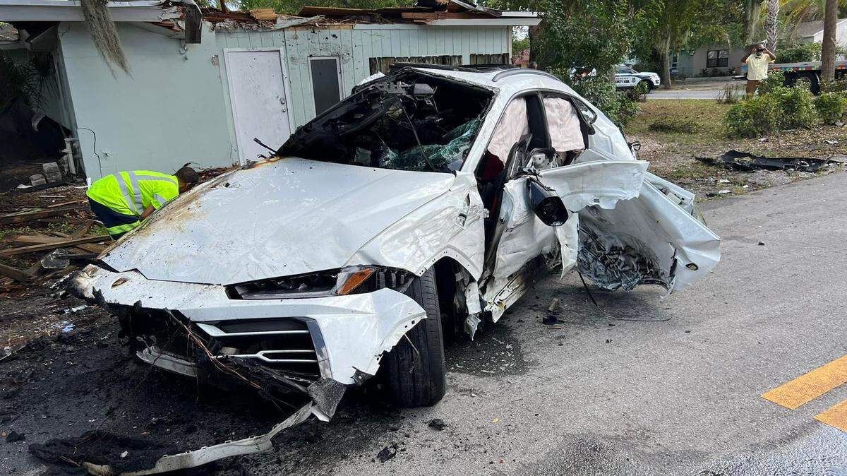 A Lamborghini SUV caught fire after it crashed into a roof Sunday