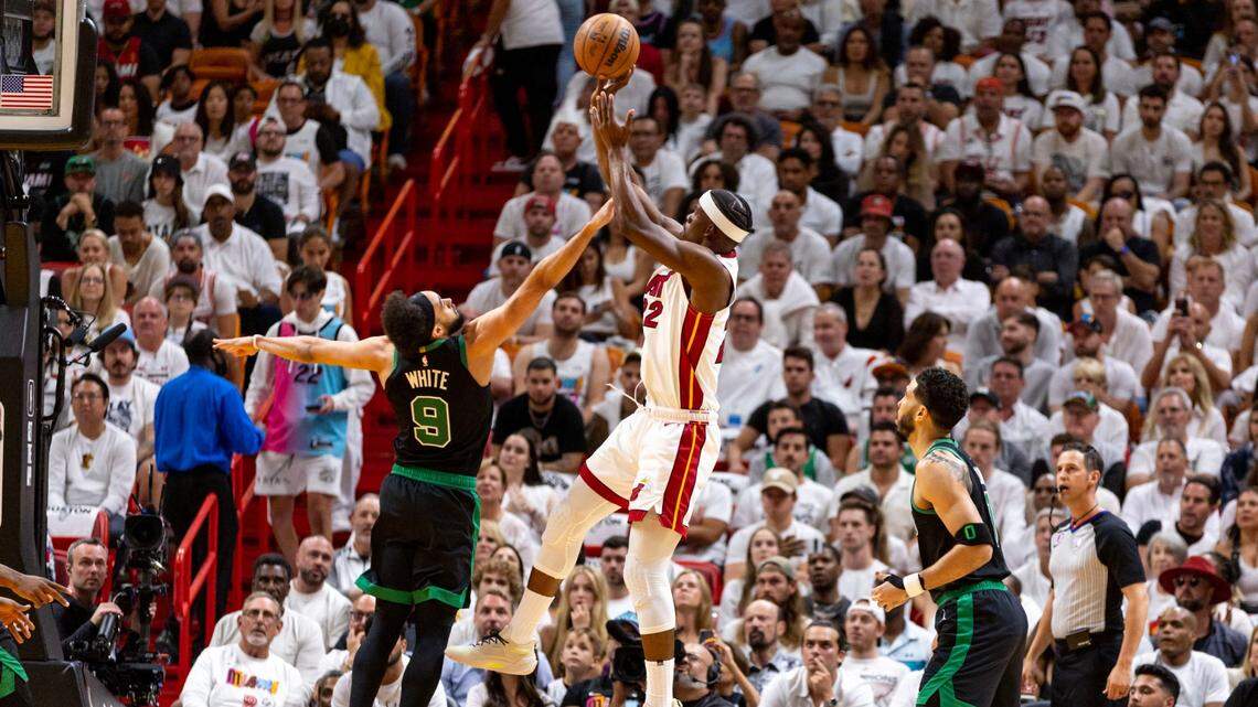 Miami Heat forward Jimmy Butler (22) shoots over Boston Celtics point guard Derrick White (9) during the first half of Game 3 of the NBA Eastern Conference Finals series at Kaseya Center in Miami, Florida, on May 21, 2023.