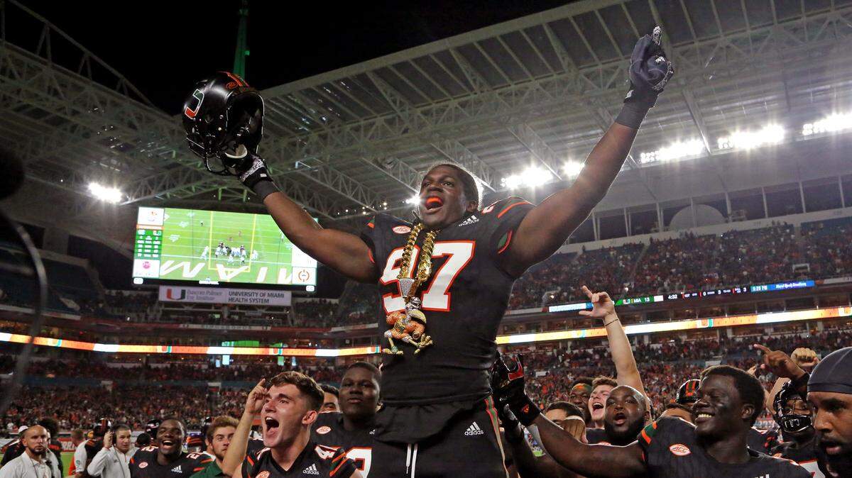 Miami Hurricanes defensive lineman Jonathan Garvin (97) celebrates with the turnover chain after scoring on a fumbled ball by North Carolina Tar Heels quarterback Nathan Elliott (11) in the first quarter as the University of Miami Hurricanes host the North Carolina Tar Heels at Hard Rock Stadium in Miami Gardens on Thursday, September 27, 2018.