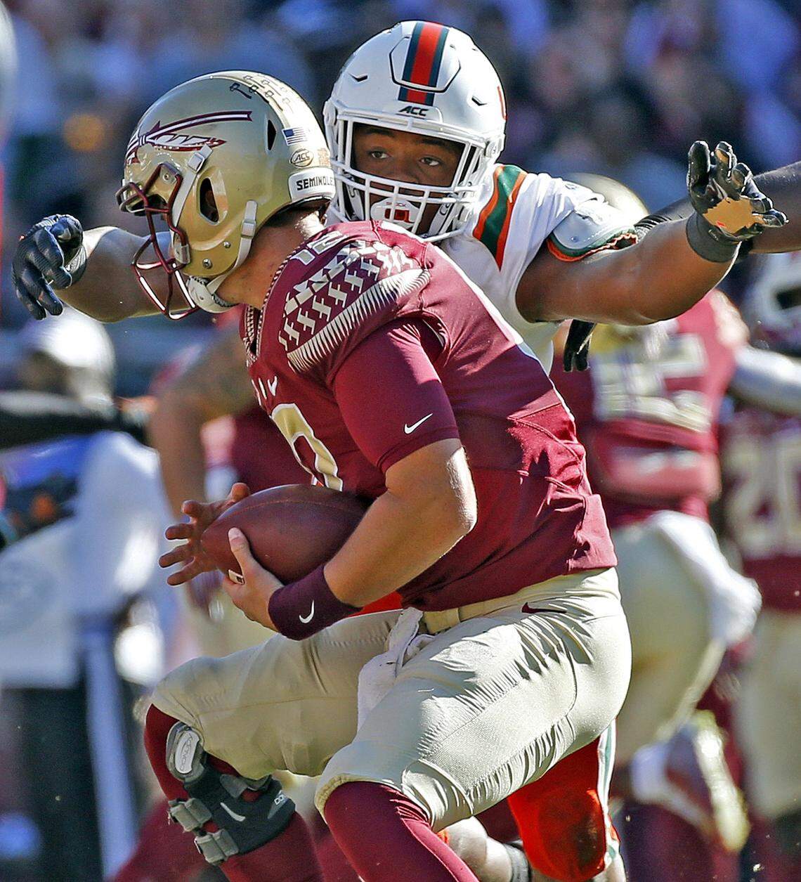 Miami Hurricanes defensive lineman Gregory Rousseau (15) sacks Florida State Seminoles quarterback Alex Hornibrook (12) in the first half as the Seminoles host the Miami Hurricanes at Doak Campbell Stadium in Tallahassee on Saturday, November 2, 2019.