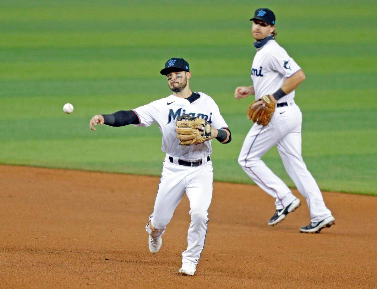 Miami Marlins shortstop Eddy Alvarez (65) throws to first to tag out New York Mets shortstop Amed Rosario (1) as the Miami Marlins host the New York Mets at Marlins Park in Miami on Wednesday, August 19, 2020.