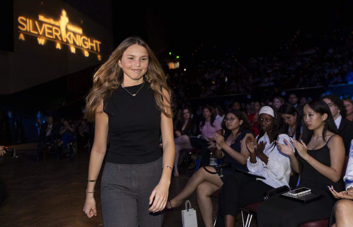 Silver Knight winner Lucia Lecour, from Pine Crest School walks to the stage after winning in the General Scholarship category.