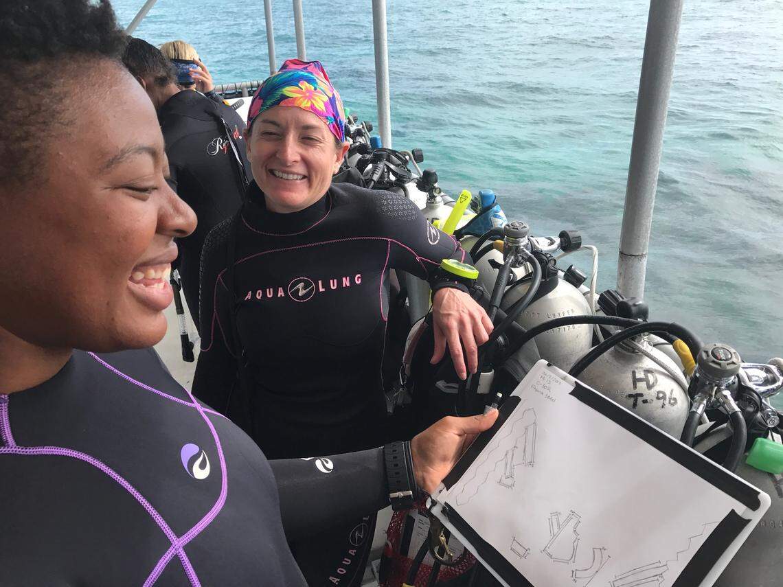 Ayana Flewellen and Melanie Casner study a map of what government researchers believe to be an 1887 shipwreck on Molasses Reef off Key Largo, Friday, June 9, 2018.