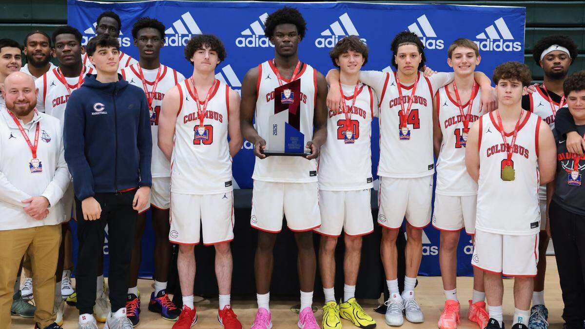 Columbus Explorers forward Caleb Gaskins (11) is photographed with his teammates holding the trophy after defeating the Palmetto Panthers during the Greater Miami Athletic Conference boys basketball finals game at Ronald W. Reagan Doral Senior High School on Saturday, Jan. 24, 2026, in Doral, Fla.