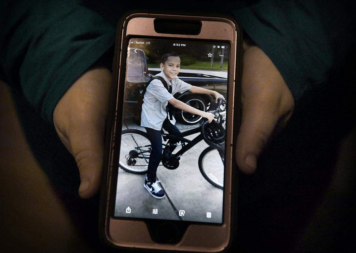 Tanya Robinson lost her son, Christian, 14, to gun violence in a drive-by shooting on Feb. 14, 2018, in Port Richey, Florida. In her hands is one of her favorite photos of Christian, on her phone. It’s from his first day of sixth grade, when he had to wear a tie.