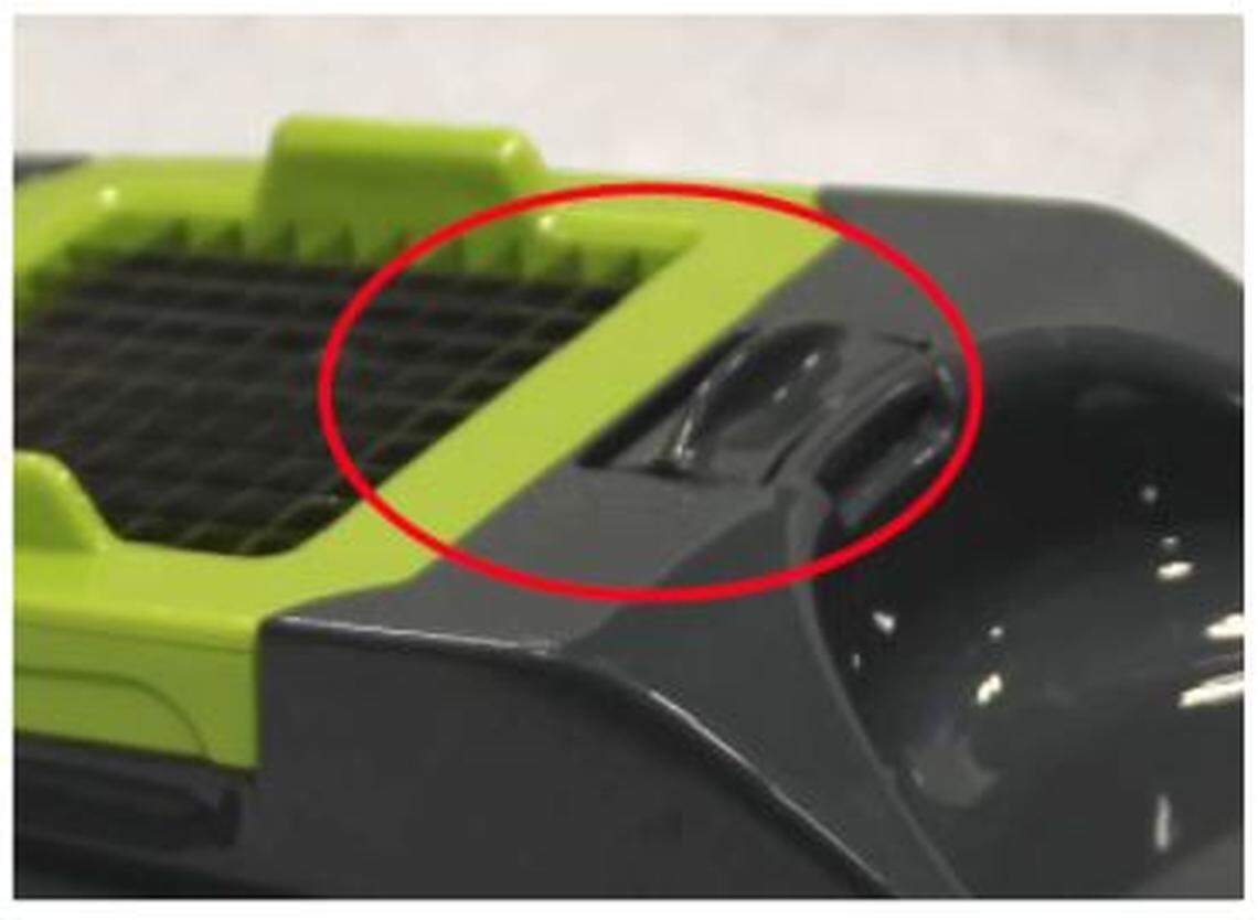 The locking tab that holds the blades in place is circled.