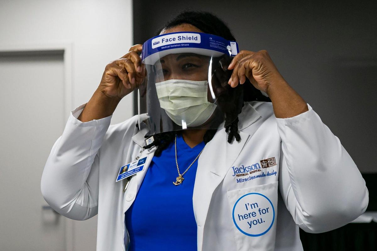 Carol Biggs, CNO at Jackson Memorial Hospital, prepares to administer doses of the Pfizer BioNTech COVID-19 vaccine in Miami, Florida, on Tuesday, December 15, 2020.