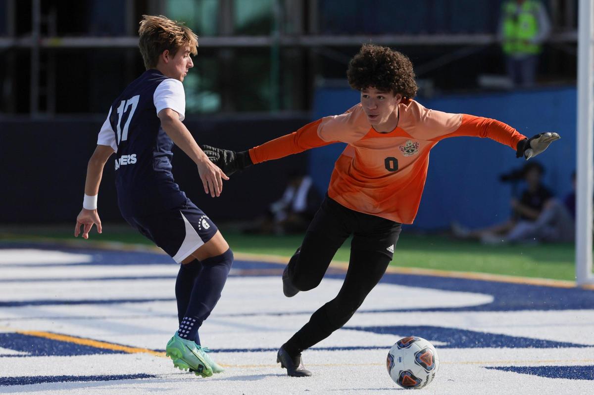 Mater lakes goalkeeper Danny Capellan (0) covers the ball from Gulliver Prep midfielder Jorge Gouvea (17) during the second half of the boys regional championship game at Gulliver Prep in Miami, Florida on Wednesday, February 14, 2024.