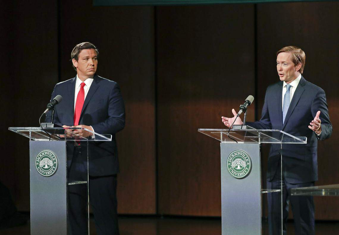 The Republican candidates for governor debated in Jacksonville on Wednesday, Aug. 8, 2018. Ron DeSantis, left, listens as Adam Putnam makes a statement.