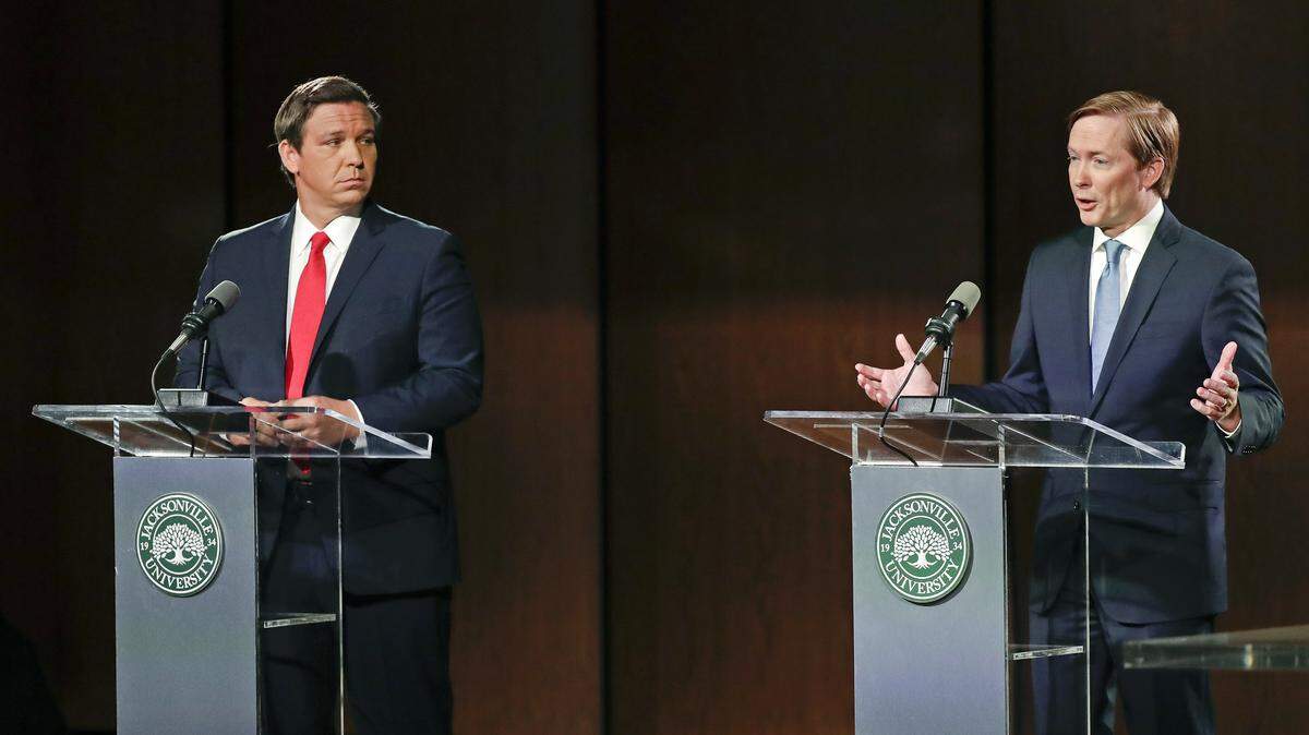 The Republican candidates for governor debated in Jacksonville on Wednesday, Aug. 8, 2018. Ron DeSantis, left, listens as Adam Putnam makes a statement.