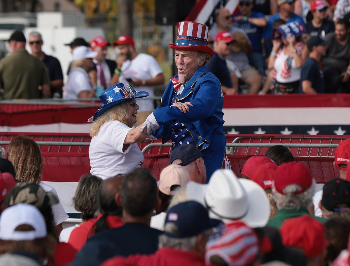 Supporters of former President Donald Trump dance to music while they wait for his arrival on Sunday, November 6, 2022 at the Miami-Dade County Fair and Exposition. Trump and a collection of other national and local Republicans campaigned with U.S. Sen. Marco Rubio on the eve of the Nov. 8 election.