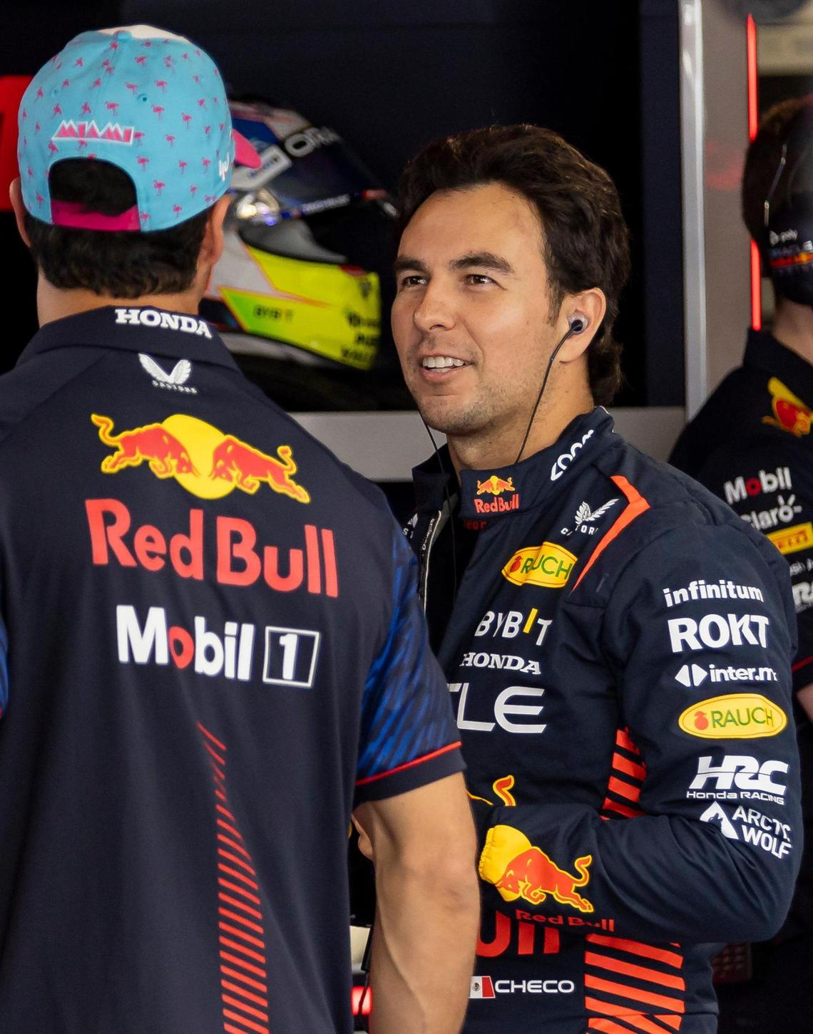 Mexican Formula One driver Sergio Perez of Red Bull Racing talks with Daniel Ricciardo before the start of the third practice session at the Formula One Miami Grand Prix at the Miami International Autodrome on Saturday, May 6, 2023, in Miami Gardens, Fla.