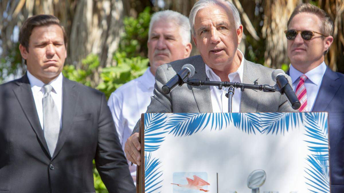 Miami-Dade Mayor Carlos Gimenez during a press conference announcing the launch of the Super Bowl LIV environmental initiative at Marjory Stoneman Douglas Biscayne Nature Center in Key Biscayne, Florida, on Monday, April 22, 2019. Behind Gimenez, from left, are Gov. Ron DeSantis, Super Bowl Host Committee chairman Rodney Barreto, and Miami Dolphins president Tom Garfinkel.