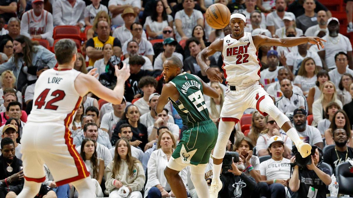 Miami Heat forward Jimmy Butler (22) passes the ball to Miami Heat forward Kevin Love (42) as Milwaukee Bucks forward Khris Middleton (22) defends in the second quarter during game 3 of the first-round playoff series at the Kaseya Center in Miami on Saturday, April 22, 2023.