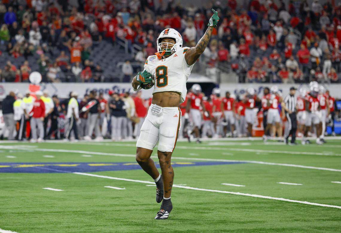 Miami Hurricanes defensive back Jakobe Thomas (8) reacts after intercepting the balll in the final minute of the game against the Ohio State Buckeyes during the College Football Playoff quarterfinal in the Cotton Bowl at AT&T Stadium in Arlington, Texas on Wednesday, December 31, 2025.