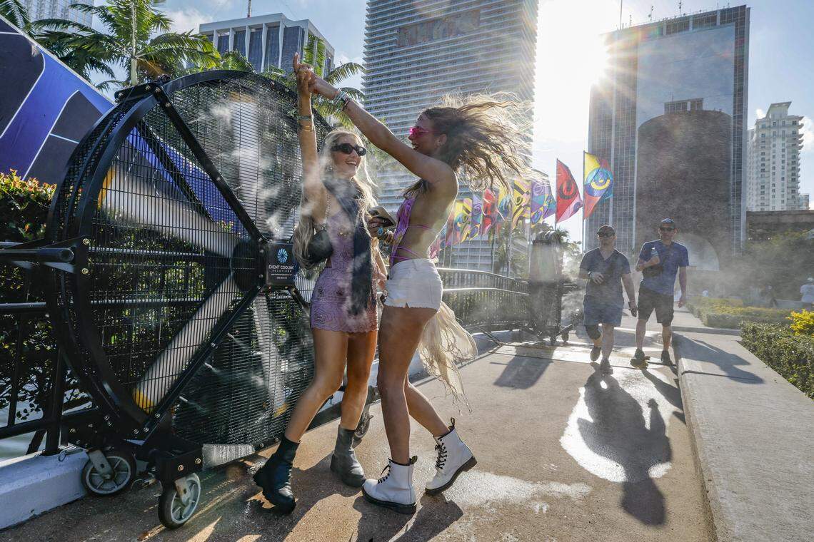 Kenna Hovey and Skyler Bunting, seen left to right, dance in a mist from cooling fans at Ultra Music Festival in Miami, Florida, on Friday, March 27, 2026.