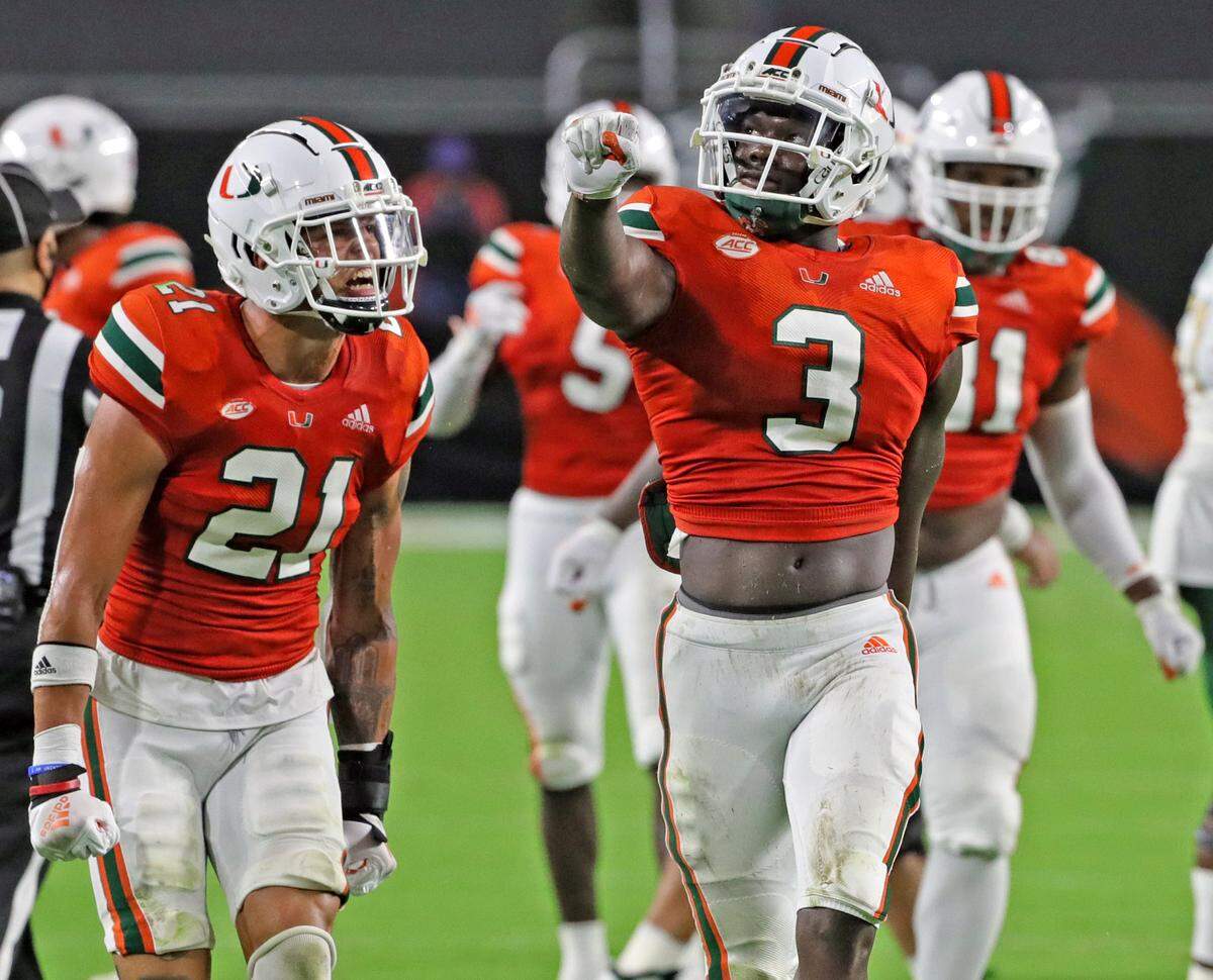 Miami Hurricanes safety Bubba Bolden (21) and Miami Hurricanes linebacker Gilbert Frierson (3) react after a defensive play in the second quarter as the University of Miami hosts the UAB Blazers at Hard Rock Stadium in Miami Gardens on Thursday, September 10, 2020.