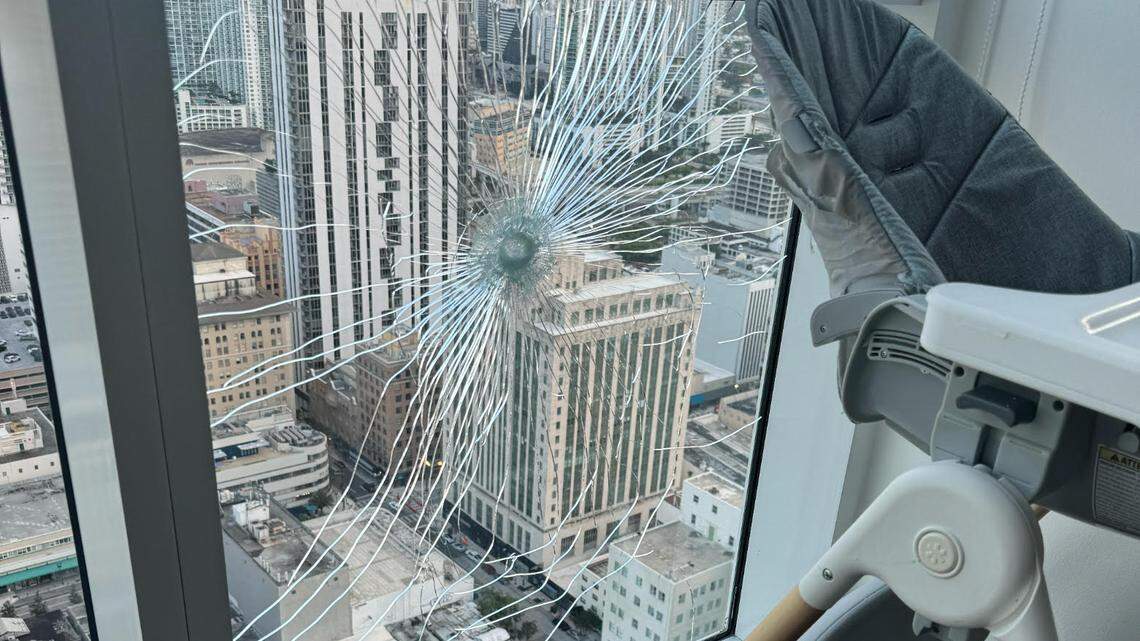 A photo taken by Vivian Olodun of the window in her downtown Miami apartment that was the apparent result of a gunshot on Sunday, May 26, 2024. The impact sent glass shards onto an empty high chair on the 45th-floor apartment that the mother of two shares with her daughters and husband. Miami police said they are investigating gunfire in the area.