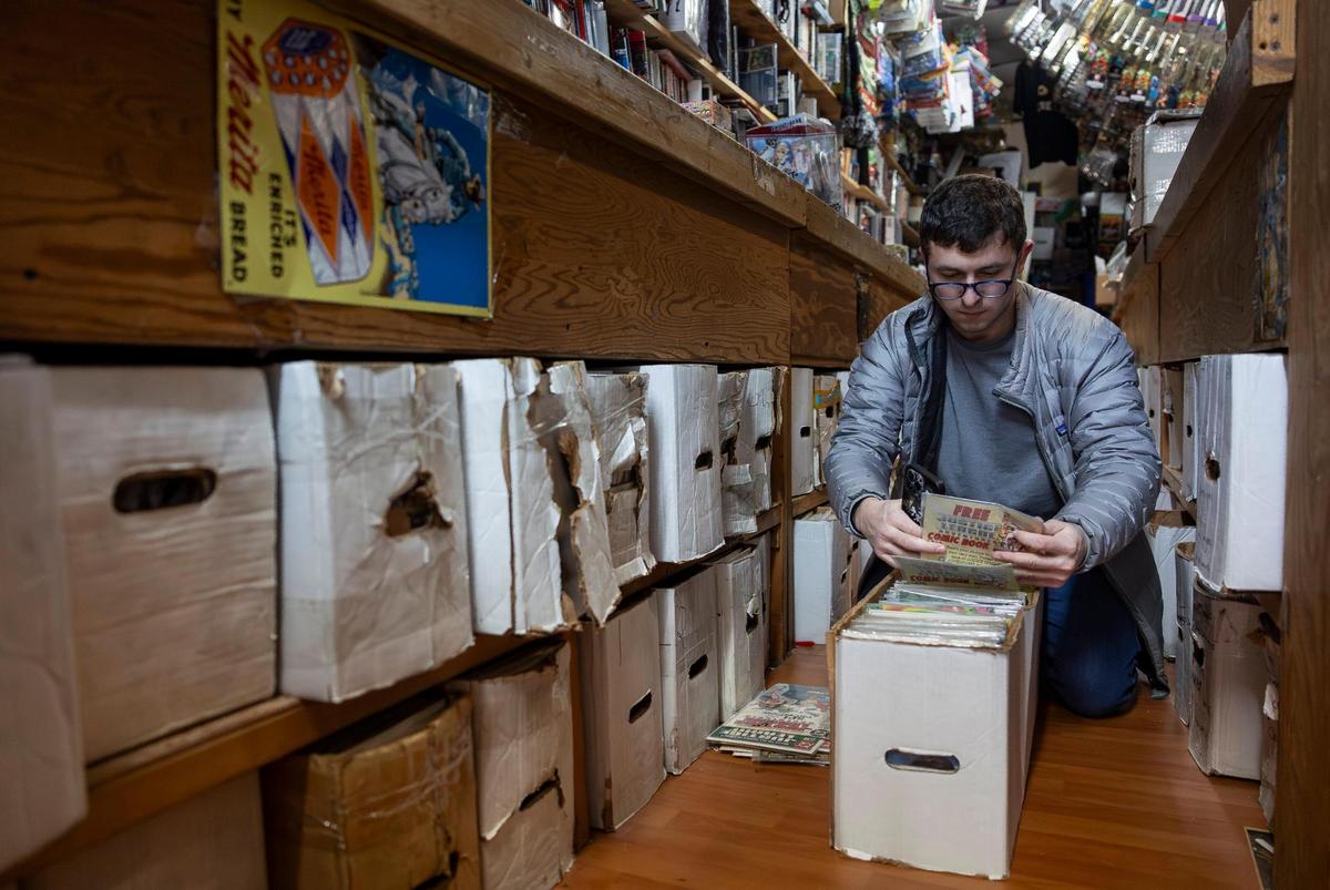 Customer Jake Berger, 27, browses through comics for sale at A&M Comics and Books on Friday, Jan. 24, 2025, in Miami, Fla.